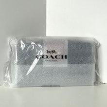 Load image into Gallery viewer, Coach clutch bag in clear packaging on a white background