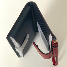 Load image into Gallery viewer, Black wallet with a red strap on a white background