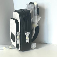 Load image into Gallery viewer, Black and white shoebox with protective packaging on a white background