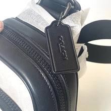 Load image into Gallery viewer, Close-up of a black shoe with a brand tag on a white background