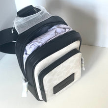 Load image into Gallery viewer, Black and gray bag with a visible brand logo on a white background