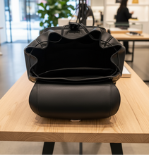 Load image into Gallery viewer, Black crossbody bag on a light gray background