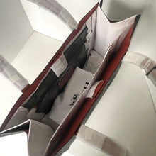 Load image into Gallery viewer, Close-up of a car seat with a visible brand logo.