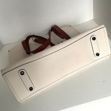 Load image into Gallery viewer, Beige leather bag with brown strap on a white surface