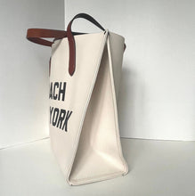 Load image into Gallery viewer, Beige handbag with 'Coach New York' text on a light gray background