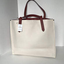 Load image into Gallery viewer, Beige tote bag with brown handles on a white background