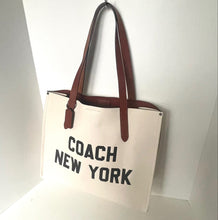 Load image into Gallery viewer, Beige tote bag with brown straps and 'Coach New York' text on a white background