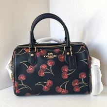 Load image into Gallery viewer, Coach handbag with cherry pattern on a white surface