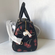 Load image into Gallery viewer, Black handbag with cherry pattern on a white surface