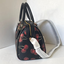 Load image into Gallery viewer, Black handbag with cherry design on a white surface