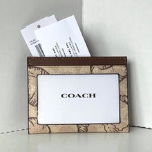 Load image into Gallery viewer, Coach cardholder with floral pattern on a light gray background