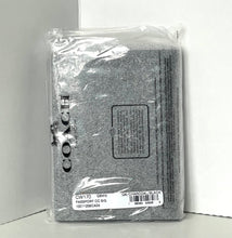 Load image into Gallery viewer, Coach passport cover in gray packaging on a white background