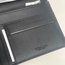 Load image into Gallery viewer, Close-up of a gray Coach wallet with card slots on a light background