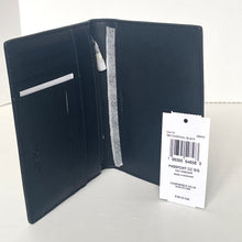 Load image into Gallery viewer, Navy leather passport holder with a visible brand tag on a white background