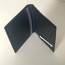 Load image into Gallery viewer, Black leather wallet on a light gray background