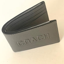 Load image into Gallery viewer, Gray leather wallet with 'Coach' branding on a beige background