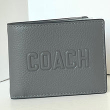 Load image into Gallery viewer, Gray leather wallet with 'COACH' embossed on it against a white background