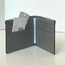 Load image into Gallery viewer, Open black leather wallet with card slots on a white background