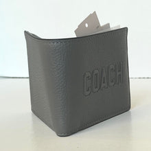 Load image into Gallery viewer, Gray leather wallet with 'COACH' embossed on it, on a light background