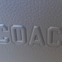 Load image into Gallery viewer, Close-up of a textured surface with embossed letters spelling 'COAC'.