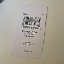 Load image into Gallery viewer, Product tag with barcode and pricing information on a beige background