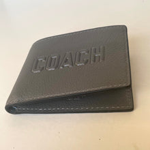 Load image into Gallery viewer, Gray leather wallet with 'COACH' embossed on a white background
