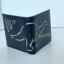 Load image into Gallery viewer, Black wallet with white and green text and graphics on a light gray background
