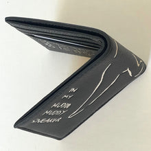 Load image into Gallery viewer, Black leather wallet with white text on a light background