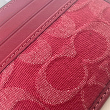 Load image into Gallery viewer, Close-up of a red textured fabric with a geometric pattern
