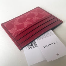 Load image into Gallery viewer, Red cardholder with Coach branding on a white background