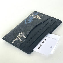 Load image into Gallery viewer, Black leather wallet with white embossed design on a white background