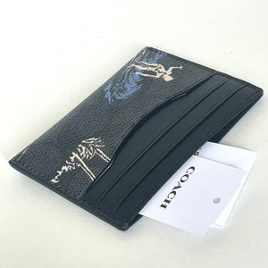 Black leather wallet with white embossed design on a white background