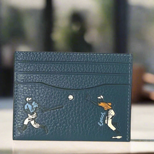 Blue leather cardholder with engraved design on a white background