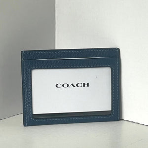 Blue Coach cardholder on a white background