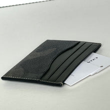 Load image into Gallery viewer, Black leather cardholder with a card inside on a light gray background