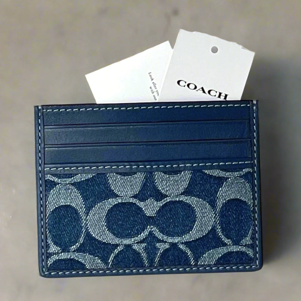 Blue cardholder with Coach logo on a white background