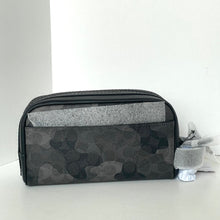 Load image into Gallery viewer, Black camouflage toiletry bag with gray interior on a white background