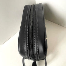 Load image into Gallery viewer, Black leather bag with a zipper on a light background
