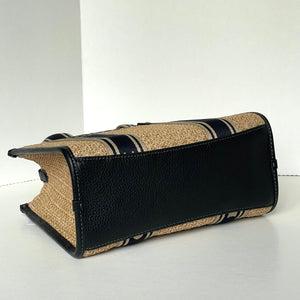 Black and beige handbag on a white background