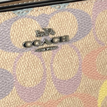 Load image into Gallery viewer, Close-up of a Coach wallet with logo and pattern