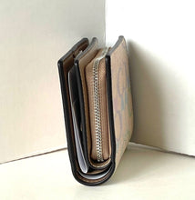 Load image into Gallery viewer, Close-up of a brown leather wallet with a zipper on a white background
