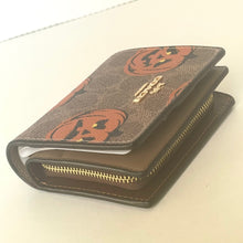 Load image into Gallery viewer, Brown wallet with pumpkin pattern on a white background