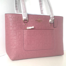 Load image into Gallery viewer, Pink Coach handbag with a visible brand logo on a white background