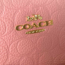 Load image into Gallery viewer, Coach logo on a pink textured background