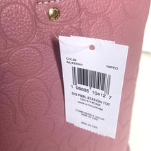 Load image into Gallery viewer, Close-up of a pink textured bag with a white label displaying product details.