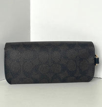 Load image into Gallery viewer, Black leather wallet with gold accents on a light gray surface