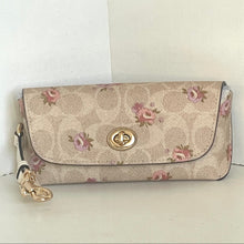 Load image into Gallery viewer, Floral patterned wallet with gold clasp on a white background