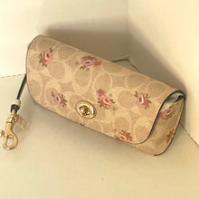 Load image into Gallery viewer, Beige handbag with floral pattern on a light beige background