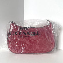 Load image into Gallery viewer, Pink Coach handbag in clear plastic packaging on a white background