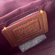 Load image into Gallery viewer, Brown leather tag with text on a purple fabric background